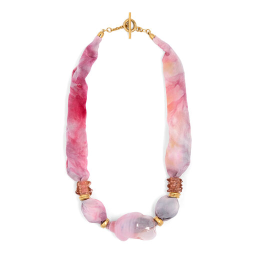 A statement pink necklace made of silk and glass.